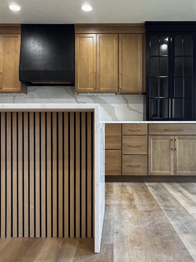 kitchen with recessed lighting, light wood-style flooring, and brown cabinets