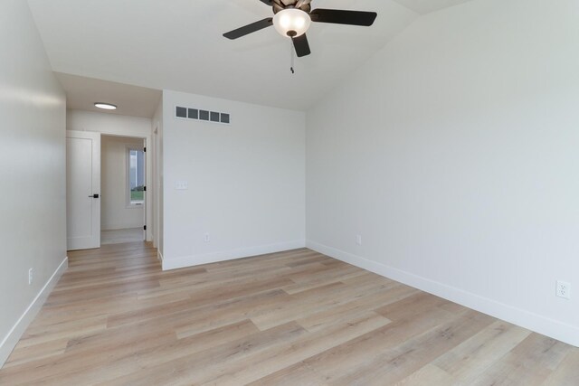 unfurnished room with ceiling fan, light wood-style flooring, baseboards, lofted ceiling, and visible vents