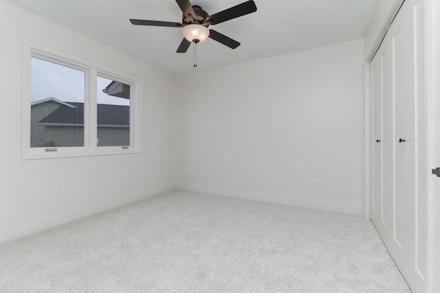 unfurnished bedroom featuring baseboards, carpet flooring, and a closet