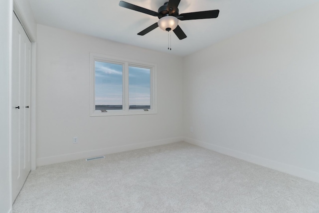 unfurnished bedroom featuring baseboards, a closet, visible vents, and carpet
