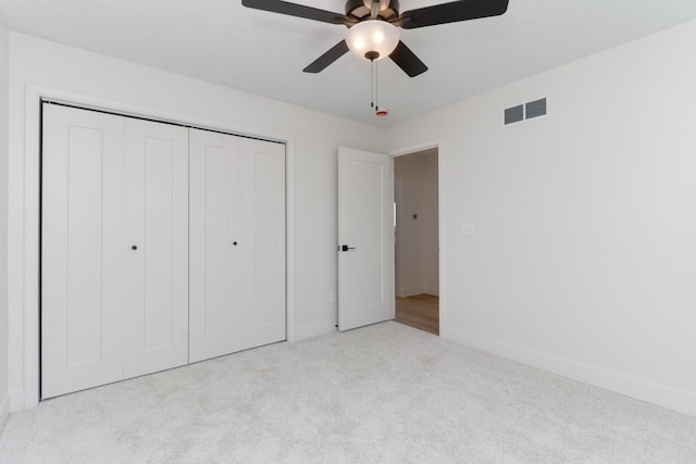 unfurnished bedroom with visible vents, carpet floors, a closet, baseboards, and ceiling fan