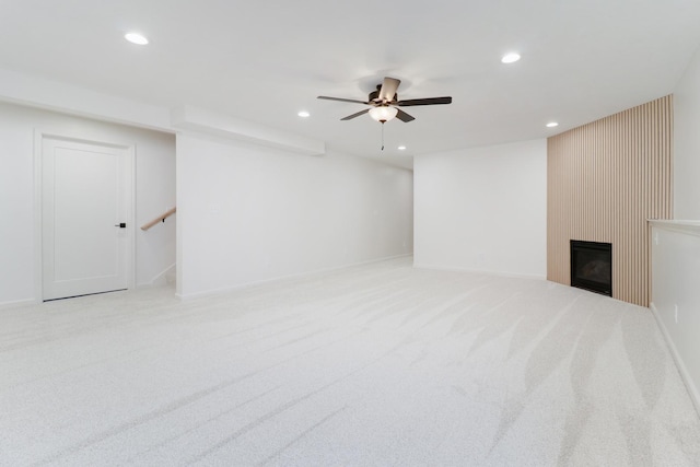 basement with carpet, a large fireplace, and recessed lighting