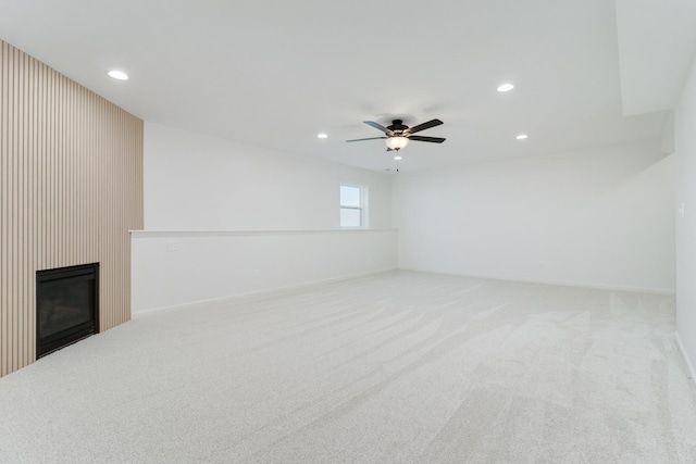 unfurnished living room featuring a fireplace, carpet flooring, ceiling fan, and recessed lighting