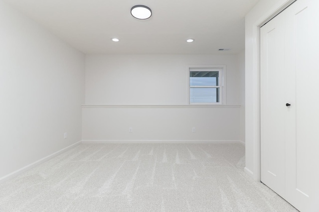 unfurnished room featuring visible vents, baseboards, recessed lighting, and light colored carpet