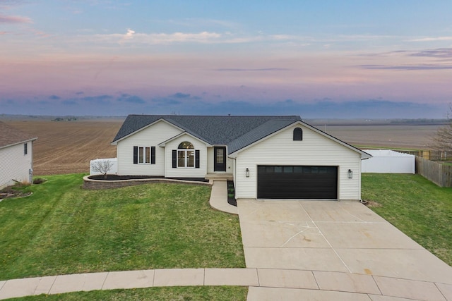 view of front of home featuring an attached garage, a lawn, fence, and concrete driveway
