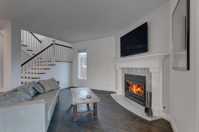 living room with dark hardwood / wood-style flooring and a fireplace