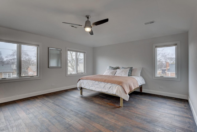 bedroom with dark hardwood / wood-style floors and ceiling fan