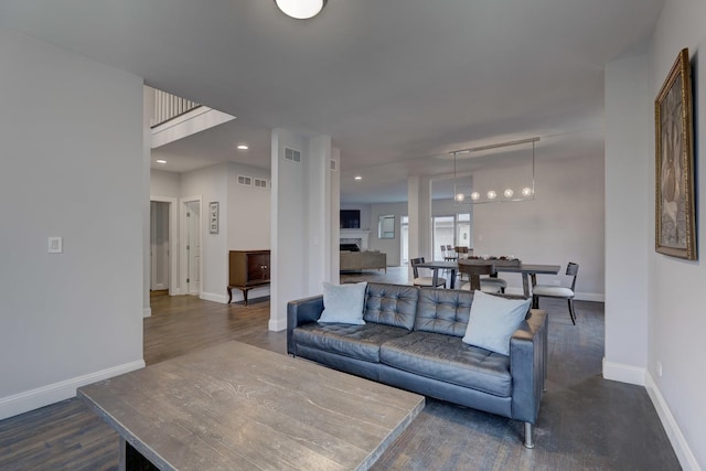 living room featuring dark wood-type flooring