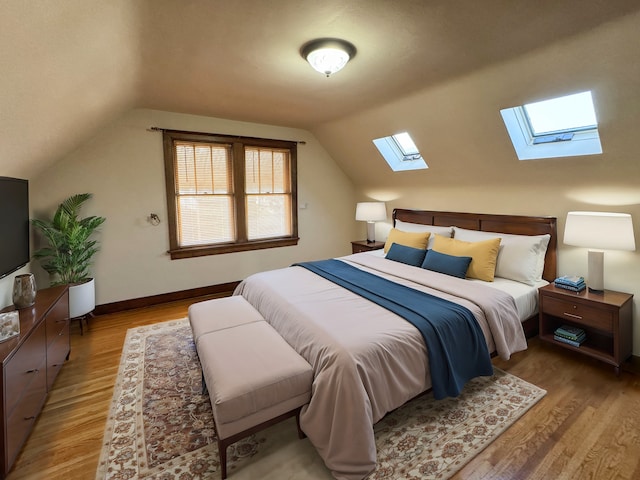 bedroom featuring light hardwood / wood-style flooring and vaulted ceiling