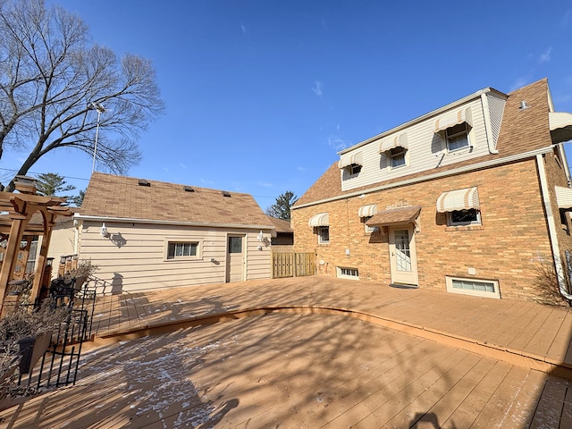 rear view of property with a wooden deck