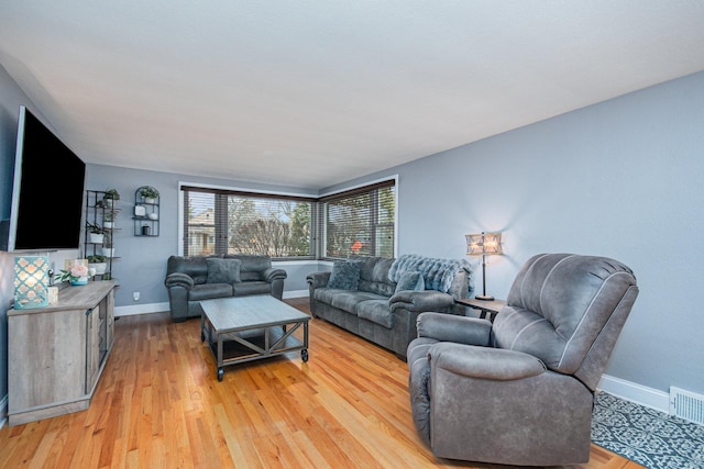 living room with light hardwood / wood-style flooring