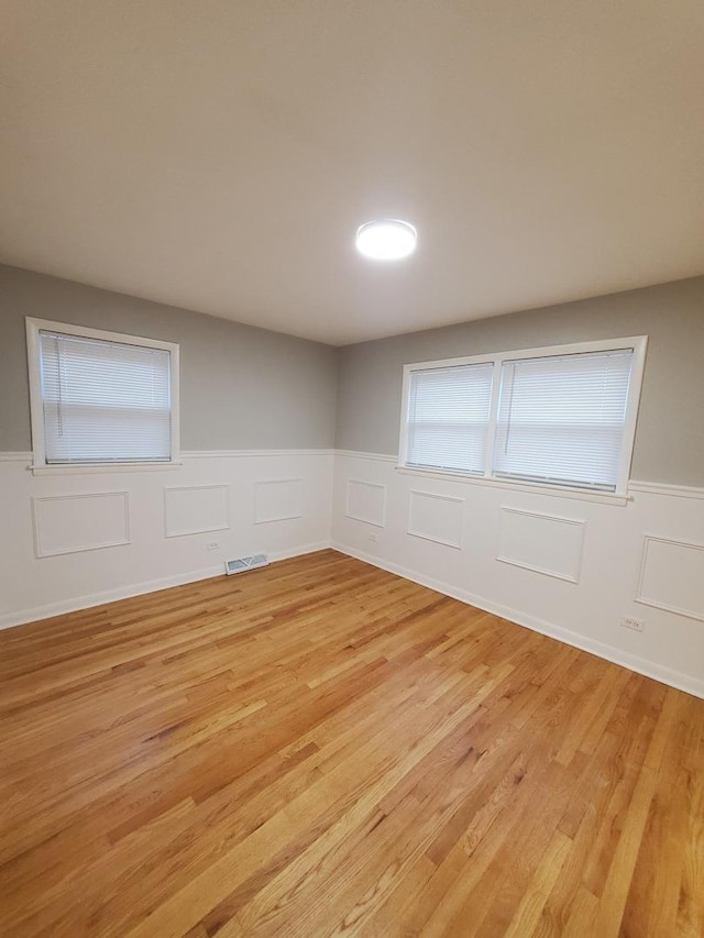 spare room featuring light wood-type flooring