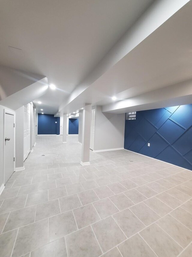 basement featuring light tile patterned flooring