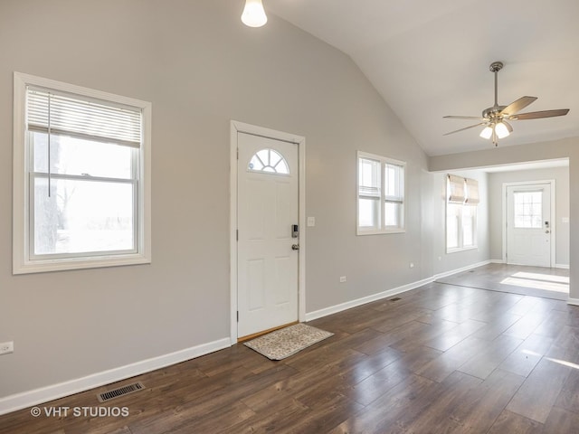 foyer entrance with vaulted ceiling, dark hardwood / wood-style floors, and ceiling fan