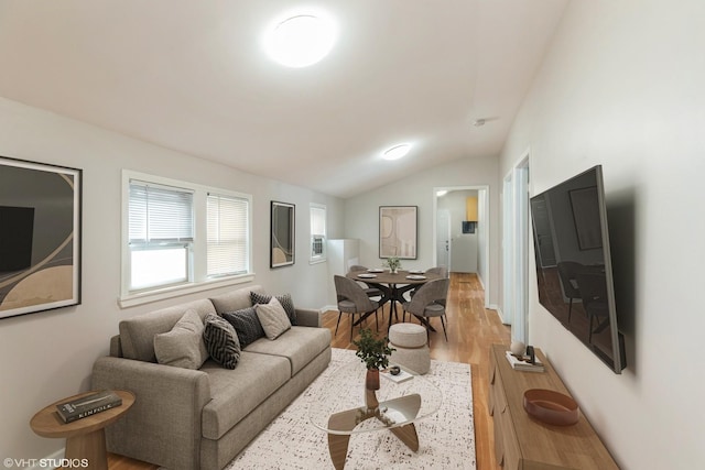 living room featuring lofted ceiling and light wood-type flooring