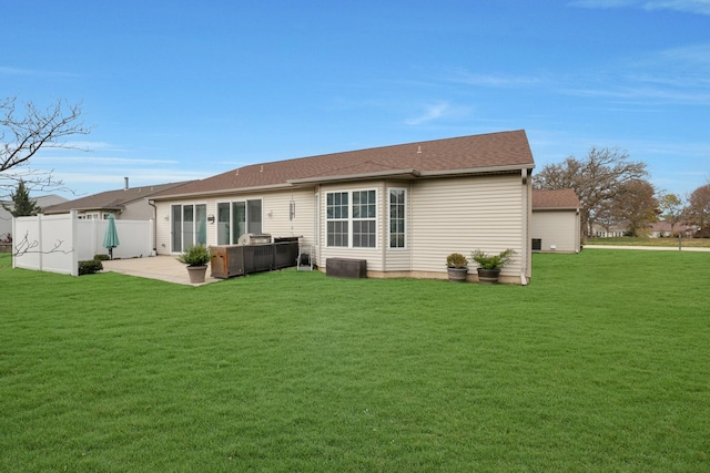 rear view of property featuring a yard and a patio area