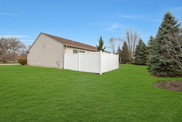 view of side of property with a yard