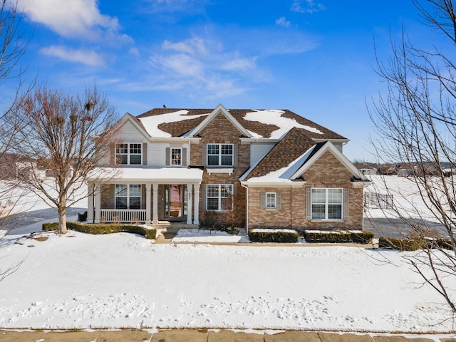 view of front of house featuring a porch and brick siding