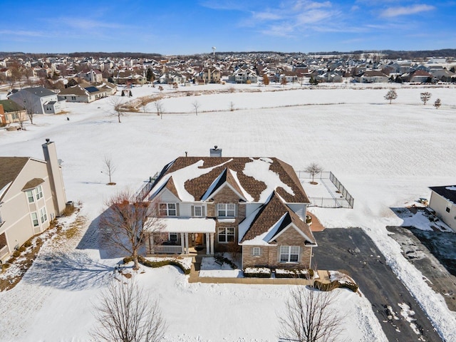 snowy aerial view featuring a residential view