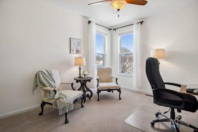 office space featuring light carpet, ceiling fan, and baseboards