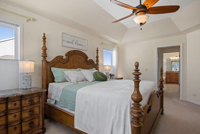 bedroom with light carpet, ceiling fan, and a tray ceiling