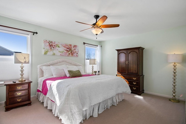 bedroom featuring light carpet, ceiling fan, and baseboards