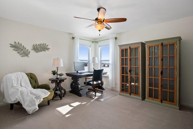 home office with ceiling fan and carpet flooring