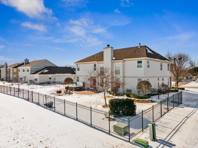 exterior space featuring a chimney, fence, and a residential view