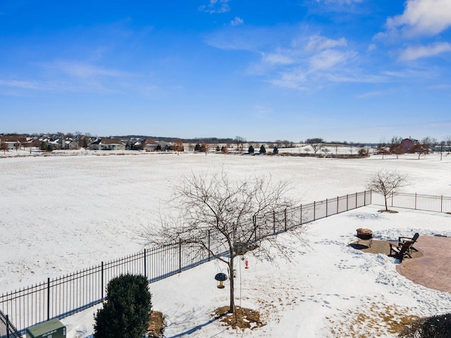 snowy yard with fence