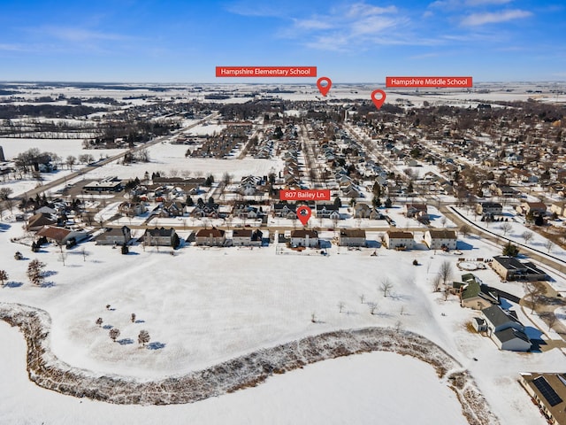 snowy aerial view featuring a residential view