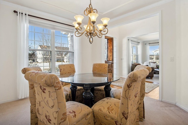 dining area with light carpet, baseboards, an inviting chandelier, and crown molding