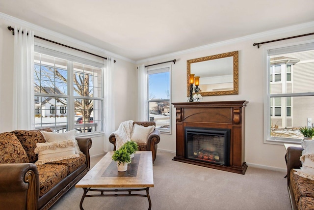 living area featuring crown molding, baseboards, a glass covered fireplace, and light colored carpet