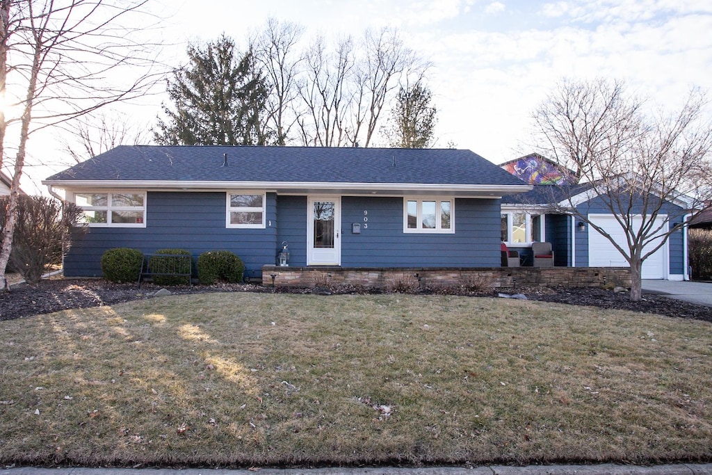 single story home featuring a garage and a front yard