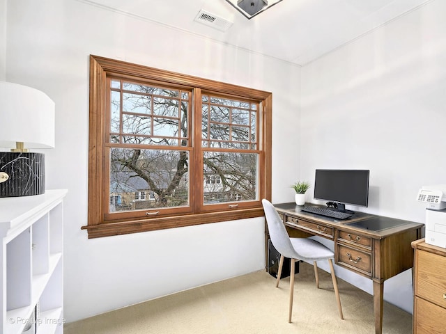 office area featuring visible vents and carpet flooring