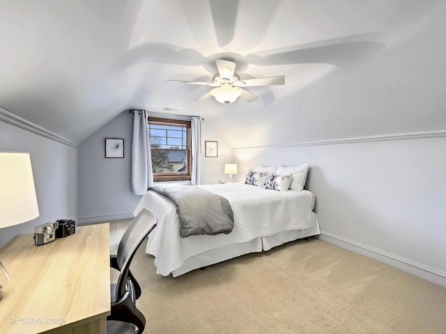 bedroom with a ceiling fan, carpet flooring, vaulted ceiling, and baseboards