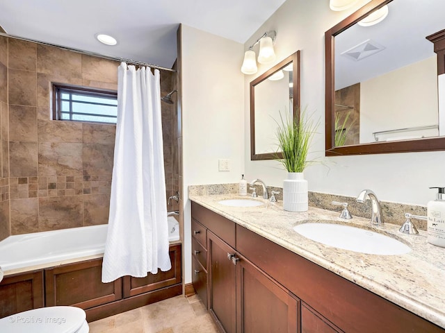 full bathroom with shower / tub combo, a sink, toilet, and double vanity