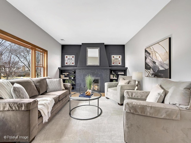 living room featuring visible vents and a fireplace