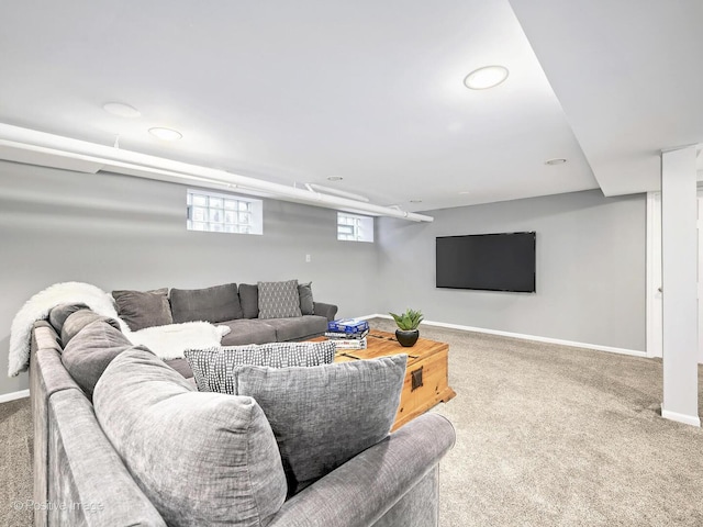 living area featuring carpet flooring and baseboards