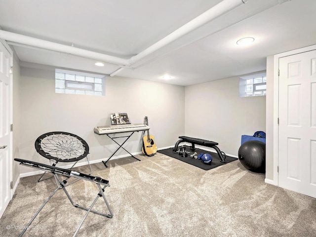 exercise area featuring carpet flooring and baseboards