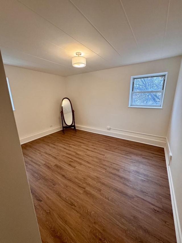 empty room featuring dark wood-type flooring