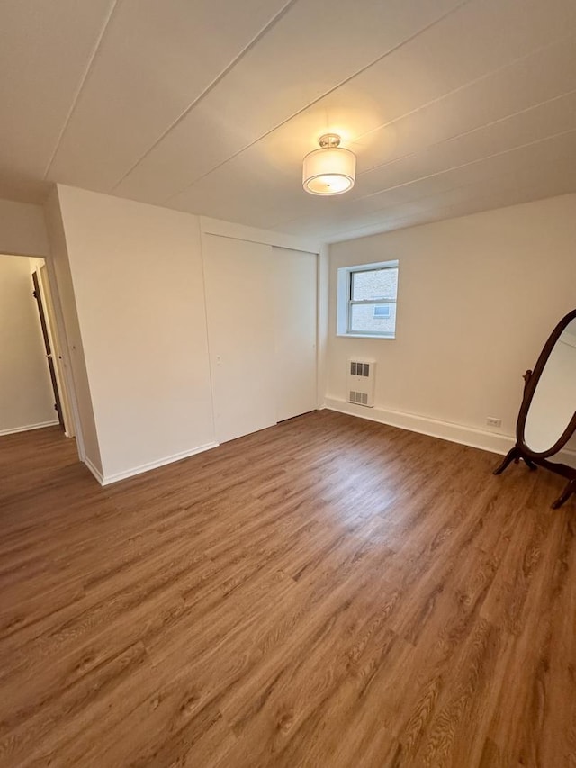 spare room featuring wood-type flooring