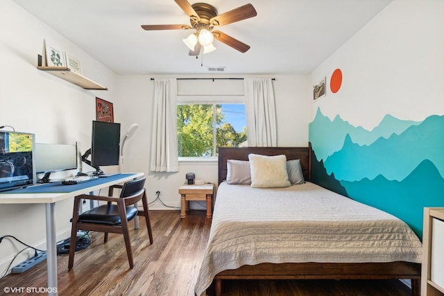 bedroom featuring visible vents, baseboards, and wood finished floors