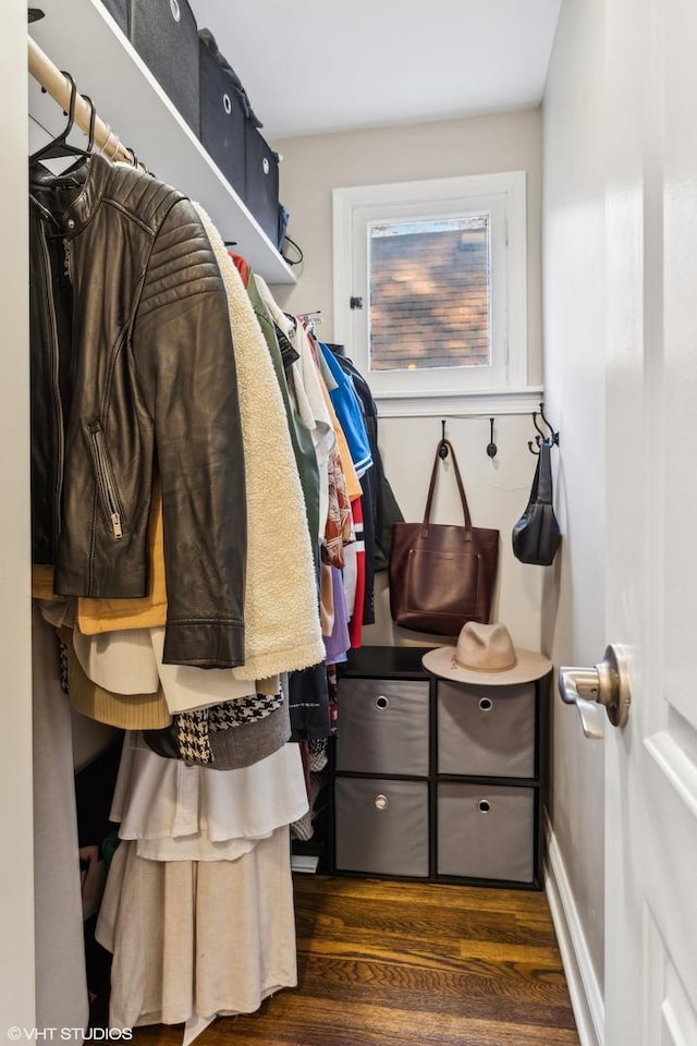 mudroom featuring dark wood-type flooring and baseboards