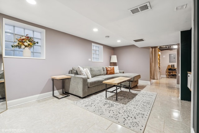 living area with recessed lighting, visible vents, and baseboards