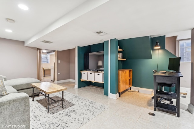 living area with recessed lighting, visible vents, and baseboards