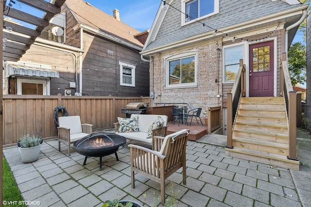 view of patio / terrace featuring an outdoor fire pit and a grill