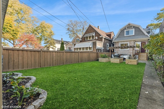 view of yard featuring fence and a vegetable garden