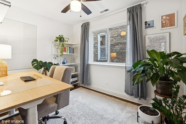 office area with a ceiling fan, baseboards, visible vents, and wood finished floors