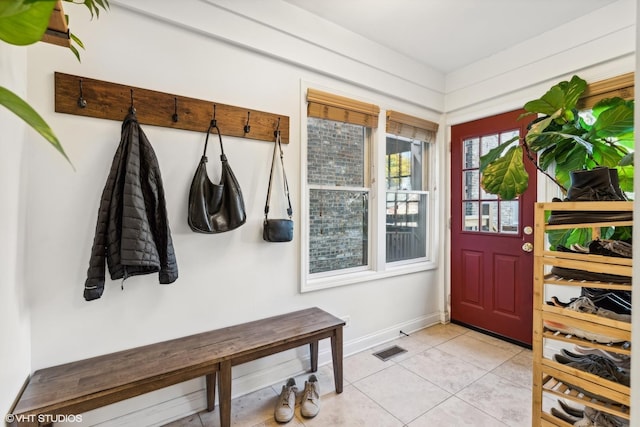 mudroom with visible vents, baseboards, and light tile patterned flooring