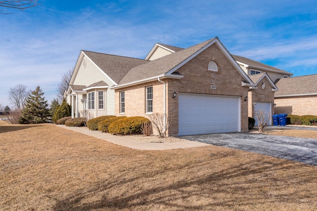 view of side of home featuring a garage and a yard